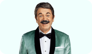 Man with mustache and tuxedo smiling