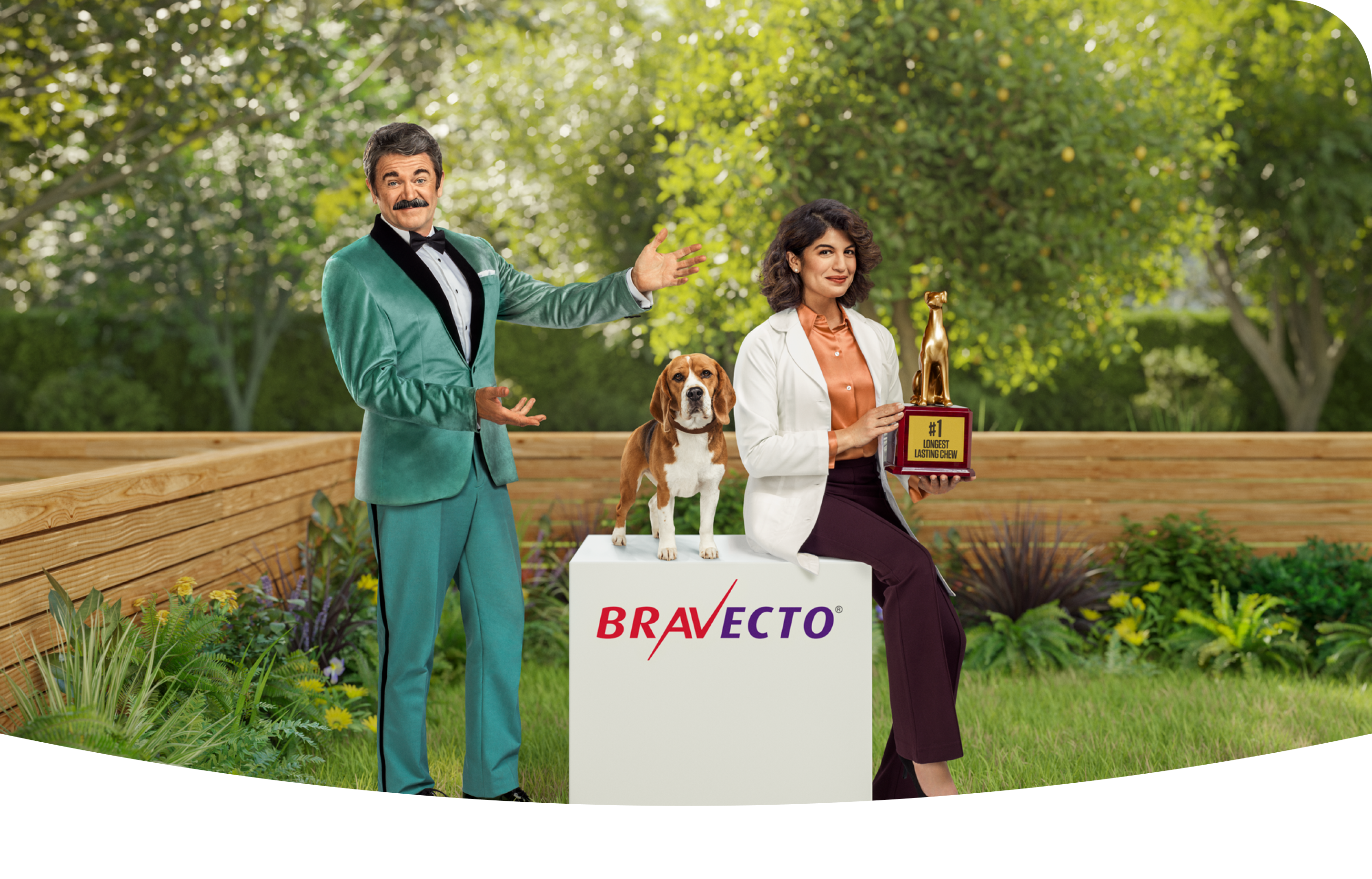 Man with mustache and tuxedo smiling with beagle and veterinarian woman with dog trophy 
